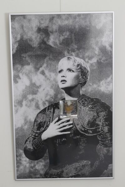 Urve Küttner. Püha Jeanne D'Arc. 2002. Ehteinstallatsioon. Pierre'i ja Gilles'i foto fragmendi reproduktsioon, hõbe, kristallid, Nina Ricci parfüümipudel.